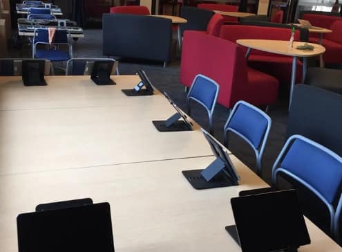 Multiple student workstations with computers, headphones, and music software.